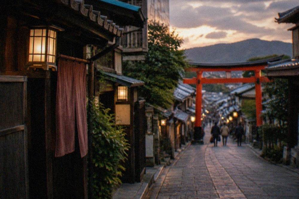 A narrow stone lane in a historic wooden district at dusk with traditional lanterns