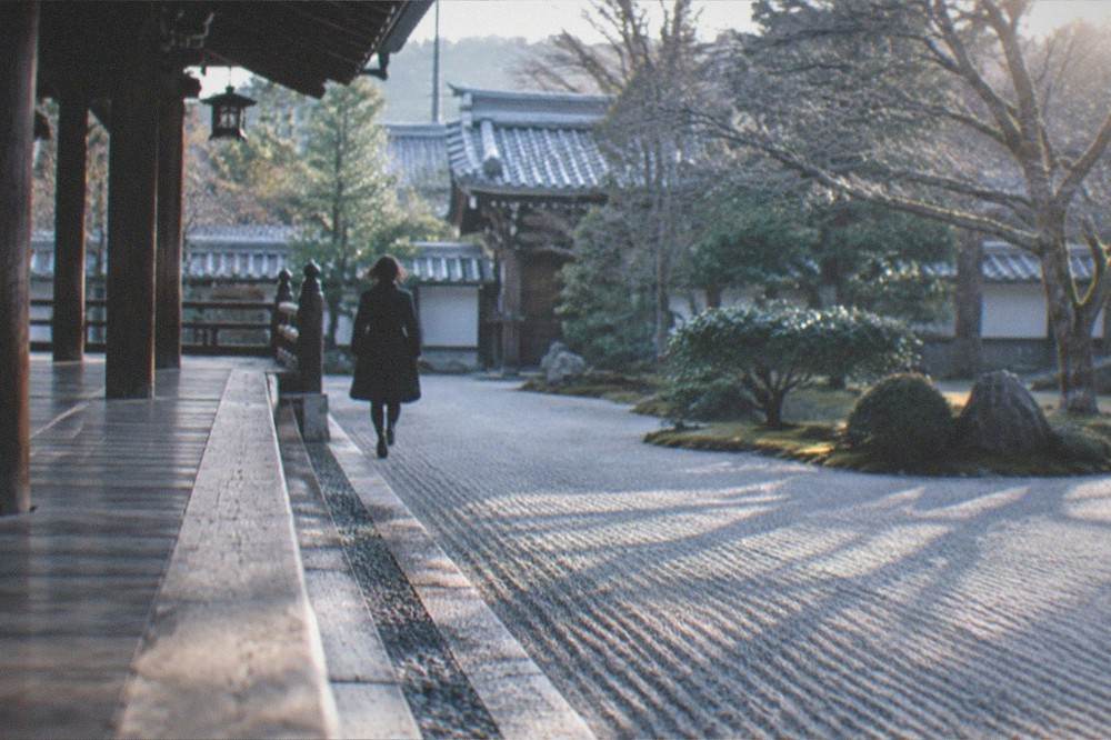 An early morning temple veranda with raked gravel and no visitors, in Kyoto