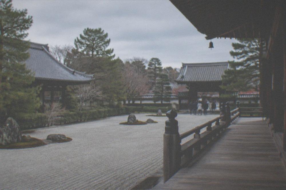 A raked gravel garden and temple veranda in quiet light