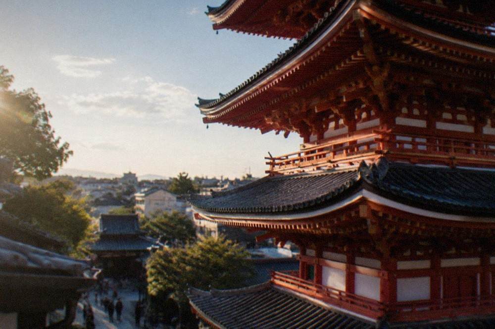 Close view of the red and white painted tiers of the To-ji pagoda against a blue sky
