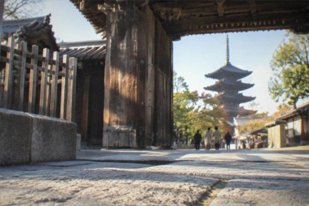 The wooden gate and grounds of To-ji temple in late afternoon light