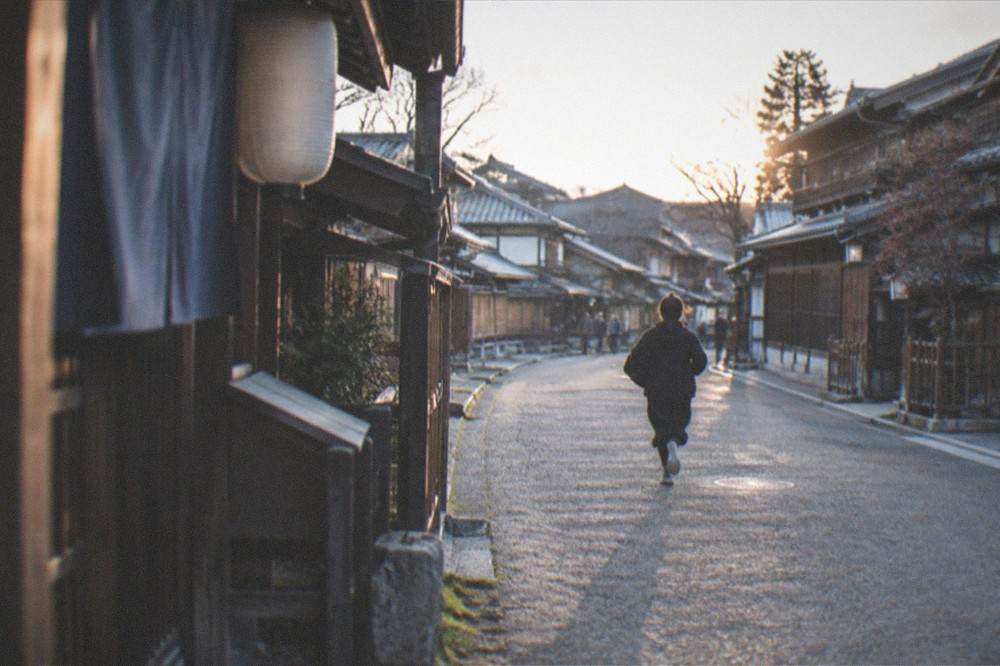 An empty period film set street in soft evening light with wooden buildings