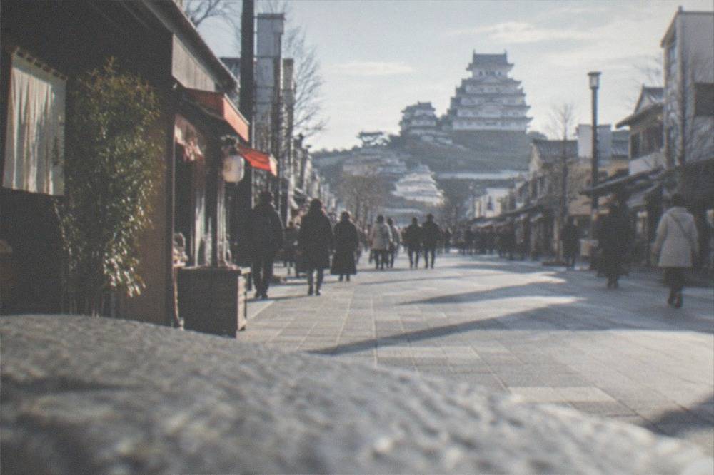 The wide main street leading from Himeji Station toward the castle with shops along both sides