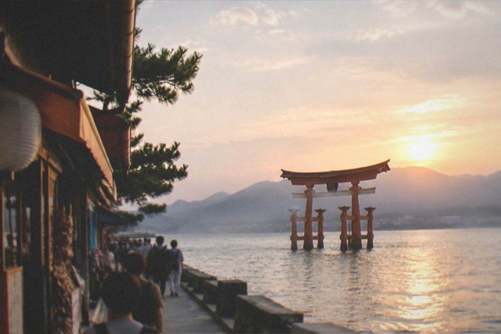 Evening light over the water at Miyajima with the mainland hills in the distance