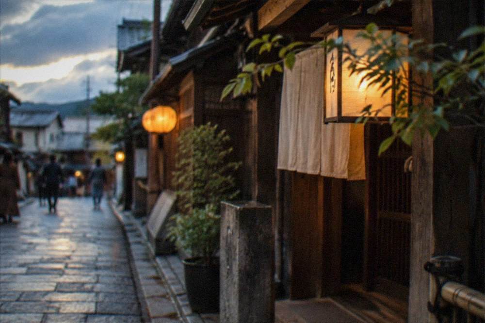 Evening lantern light on a narrow stone-paved street in old Kyoto