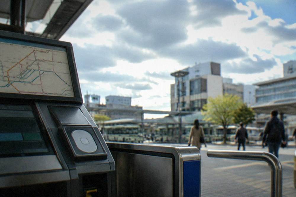 A fare machine and route map displayed inside a Japanese bus terminal