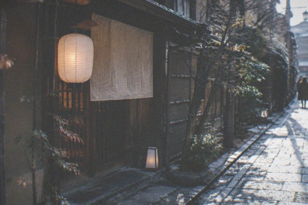 A quiet traditional restaurant entrance with a stone path and a paper lantern