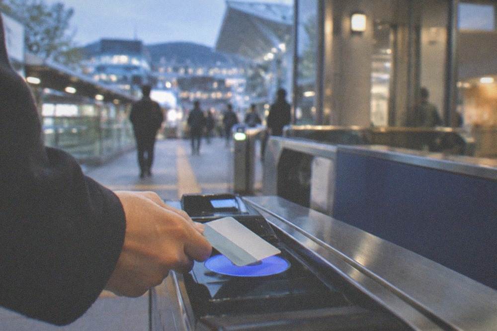 A contactless travel card being tapped on a station ticket gate