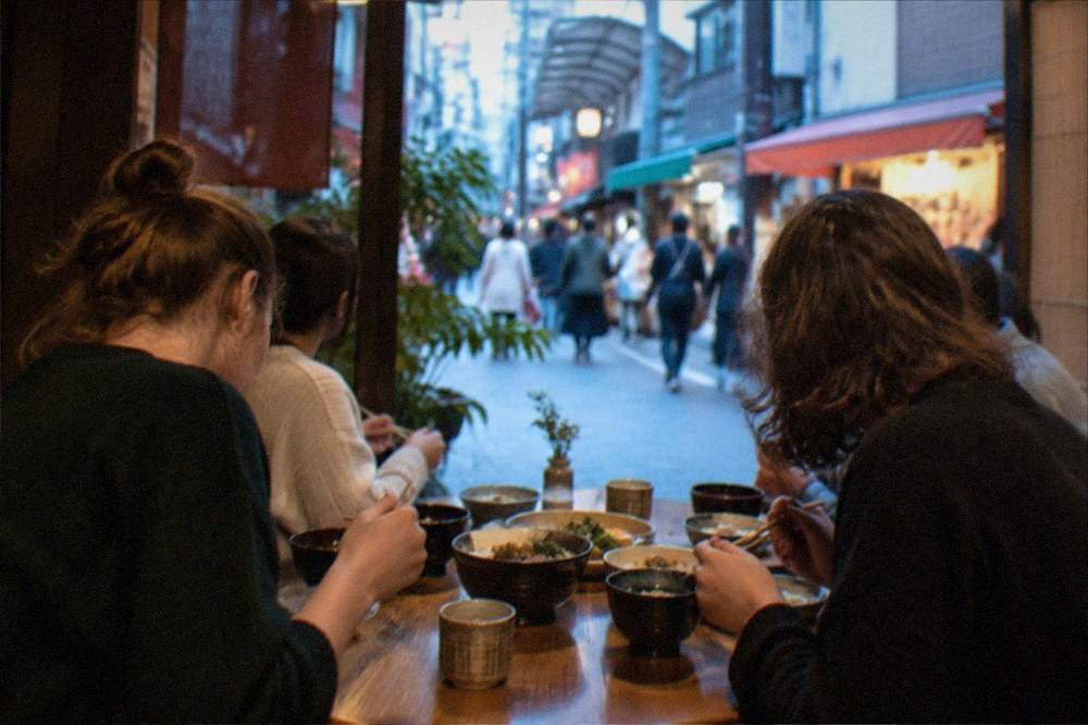 A cooking class group sitting down to eat the meal they prepared together in Kyoto