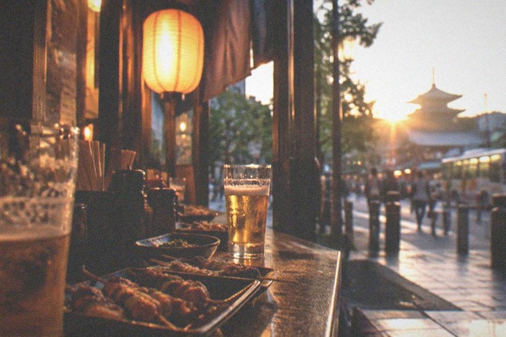 A small lantern-lit izakaya counter at night with grilled skewers and beer glasses