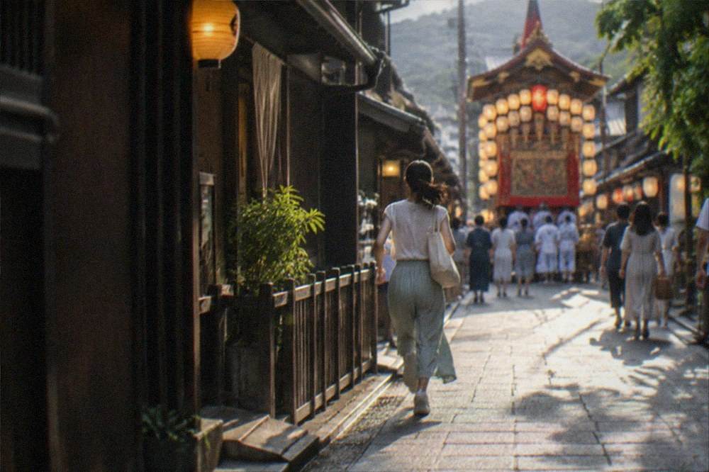 A lit festival float standing in a Kyoto street at night during Gion Matsuri