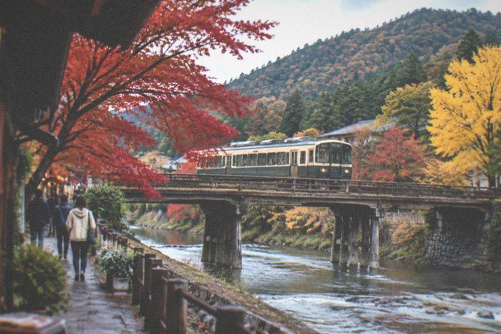 A narrow local train crossing a wooden bridge over a mountain river in autumn