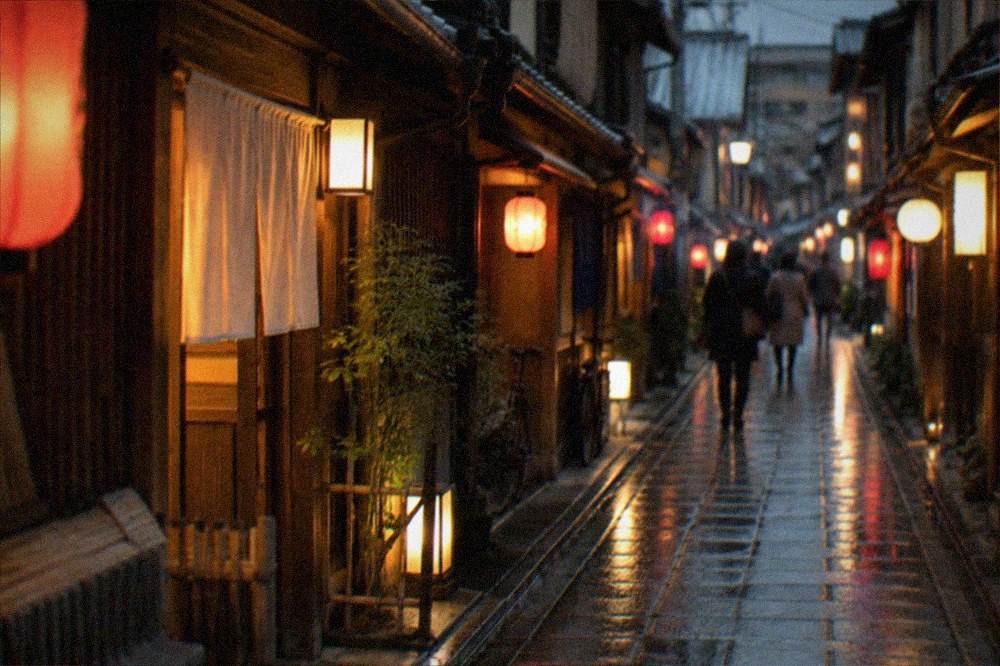 A narrow Pontocho alley at night with lanterns lighting the wooden facades of small bars and restaurants