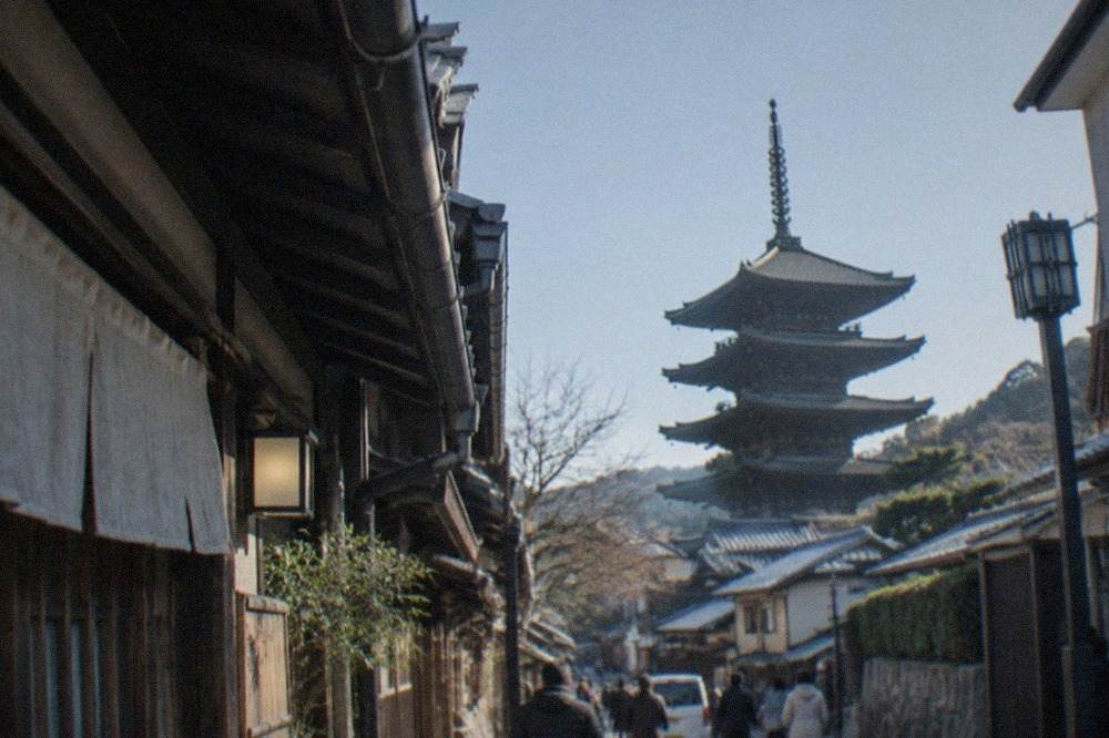 Kyoto rooftops and temple pagodas under a clear morning sky