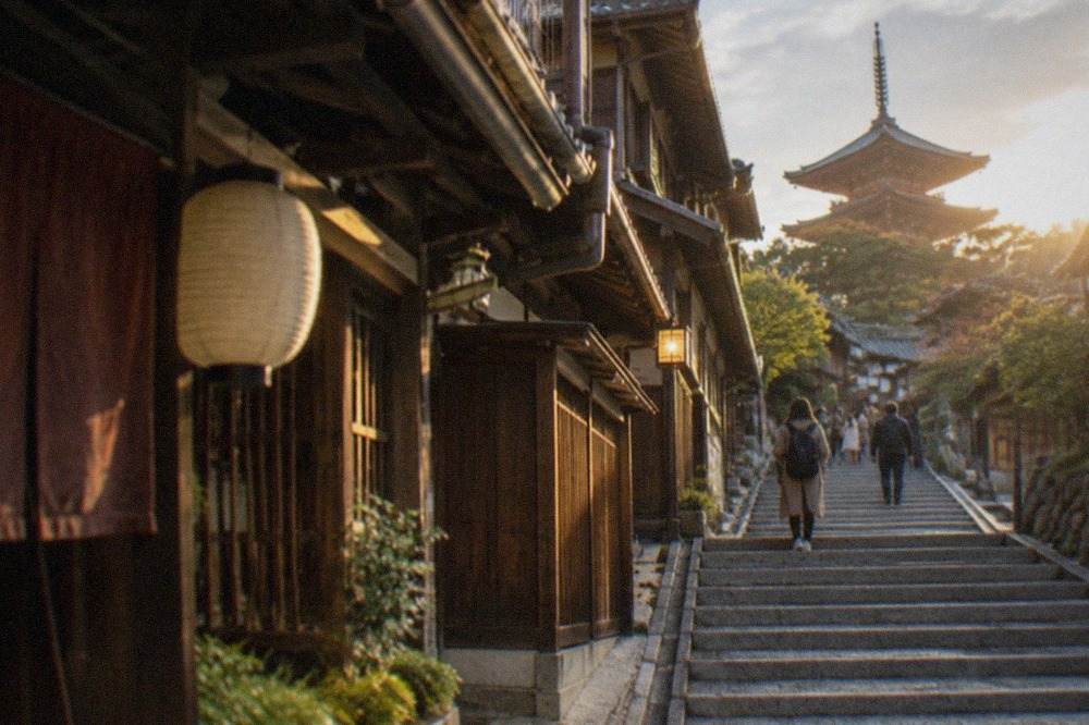 Stone steps rising through traditional wooden buildings toward Kiyomizu-dera in Higashiyama